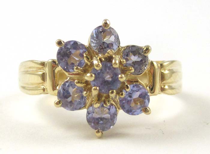 Appraisal: TANZANITE AND TEN KARAT GOLD FLORAL RING set with seven