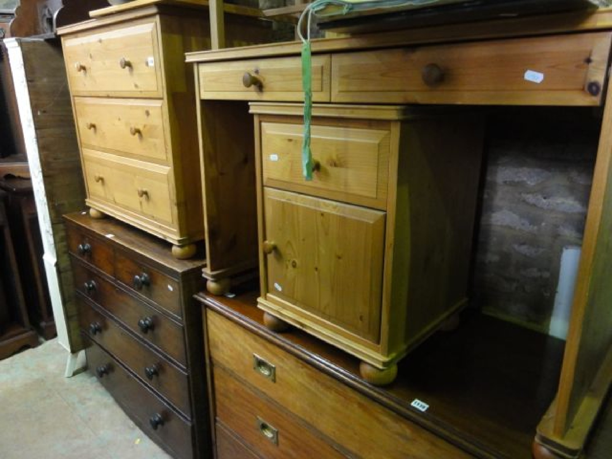 Appraisal: A contemporary stripped pine three drawer bedroom chest matching kneehole