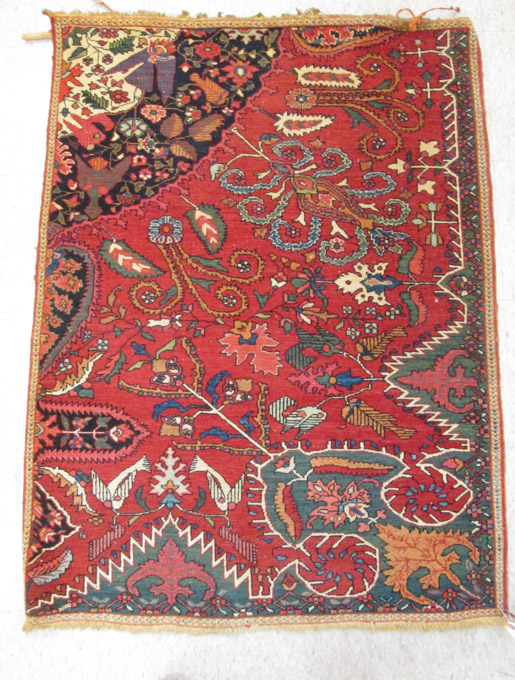 Appraisal: AN UNUSUAL HAND KNOTTED WALL RUG featuring a one-quarter floral