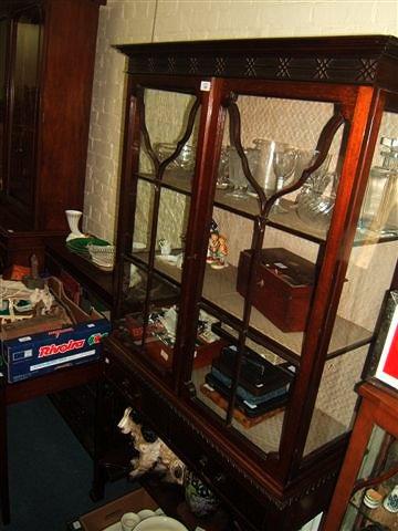 Appraisal: A mahogany display cabinet the pediment with blind fretwork decoration