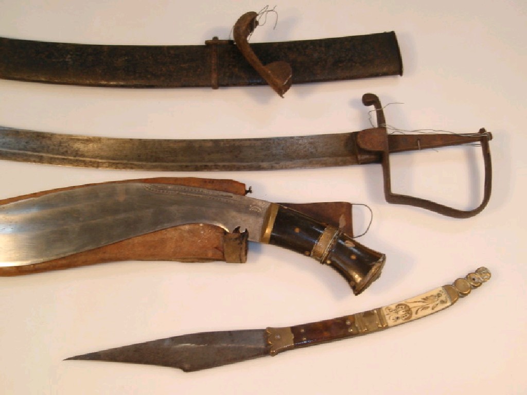 Appraisal: A Kukri knife with horn handle and an antique sabre