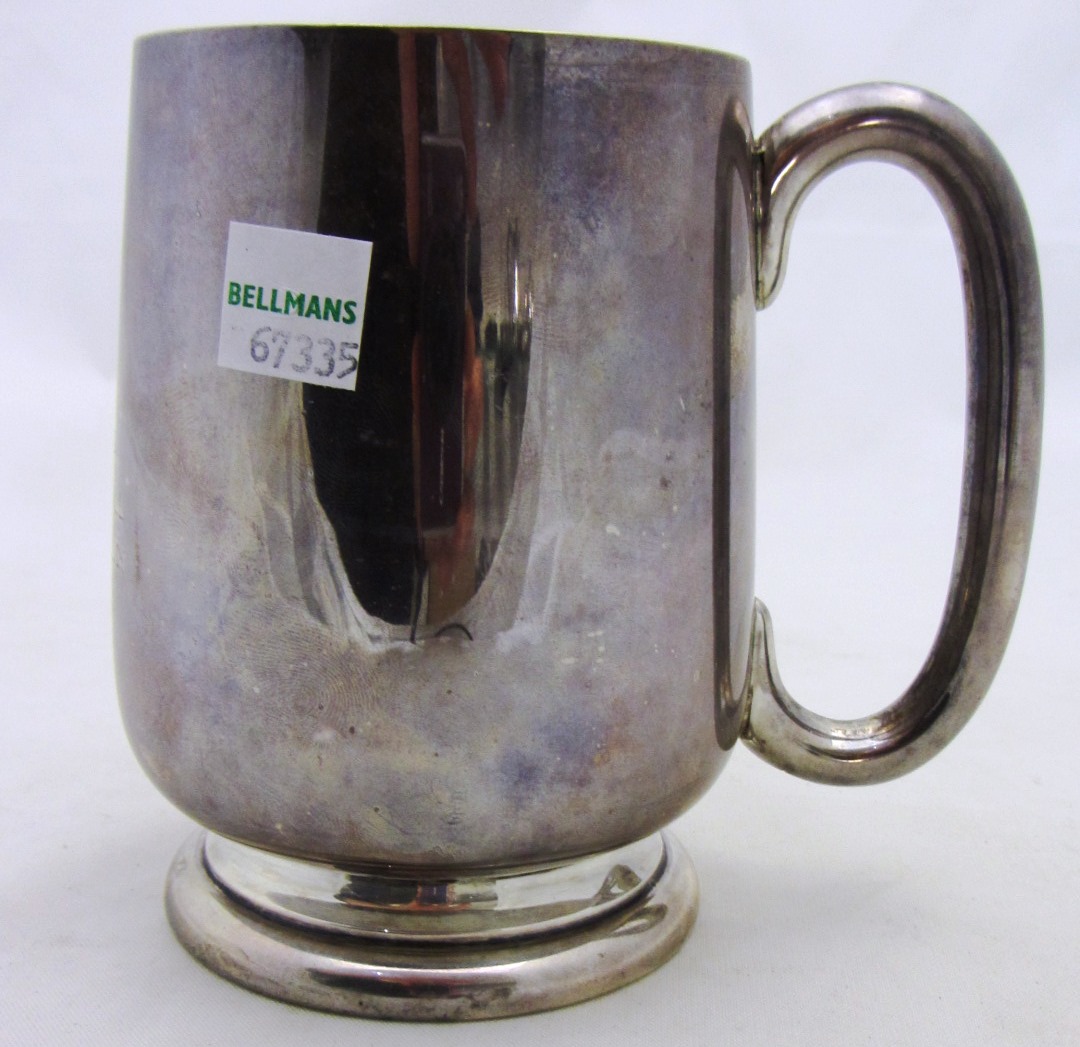 Appraisal: A silver mug of tapering form with a C shaped