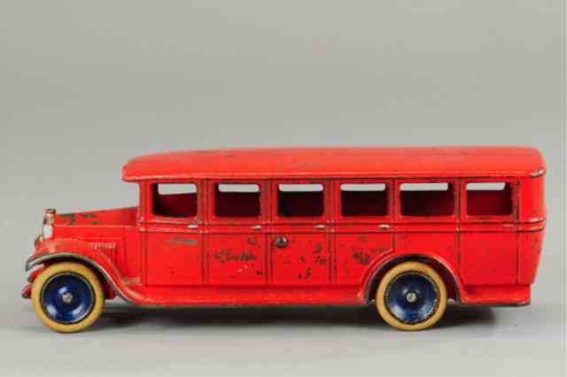 Appraisal: SKOGLUND OLSON BUS Cast iron painted in red overall rubber