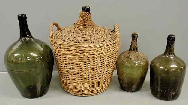 Appraisal: Four green glass bottles largest with wicker covering x