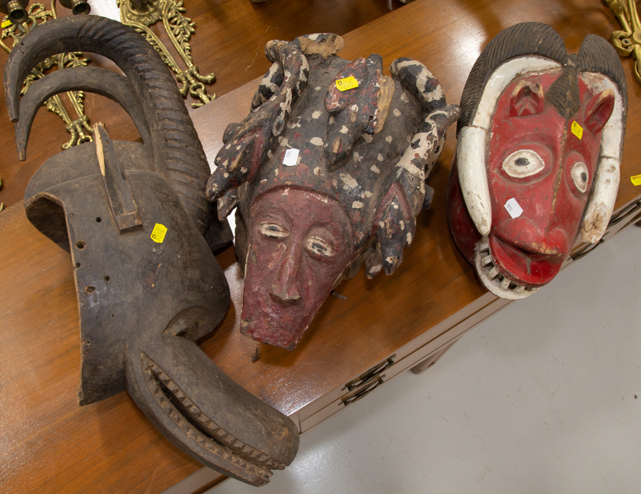 Appraisal: THREE AFRICAN MASKS All th century including a Gouro painted