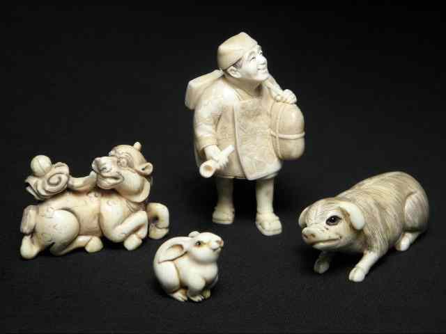 Appraisal: Four Japanese carved ivory netsukes Includes a man carrying a