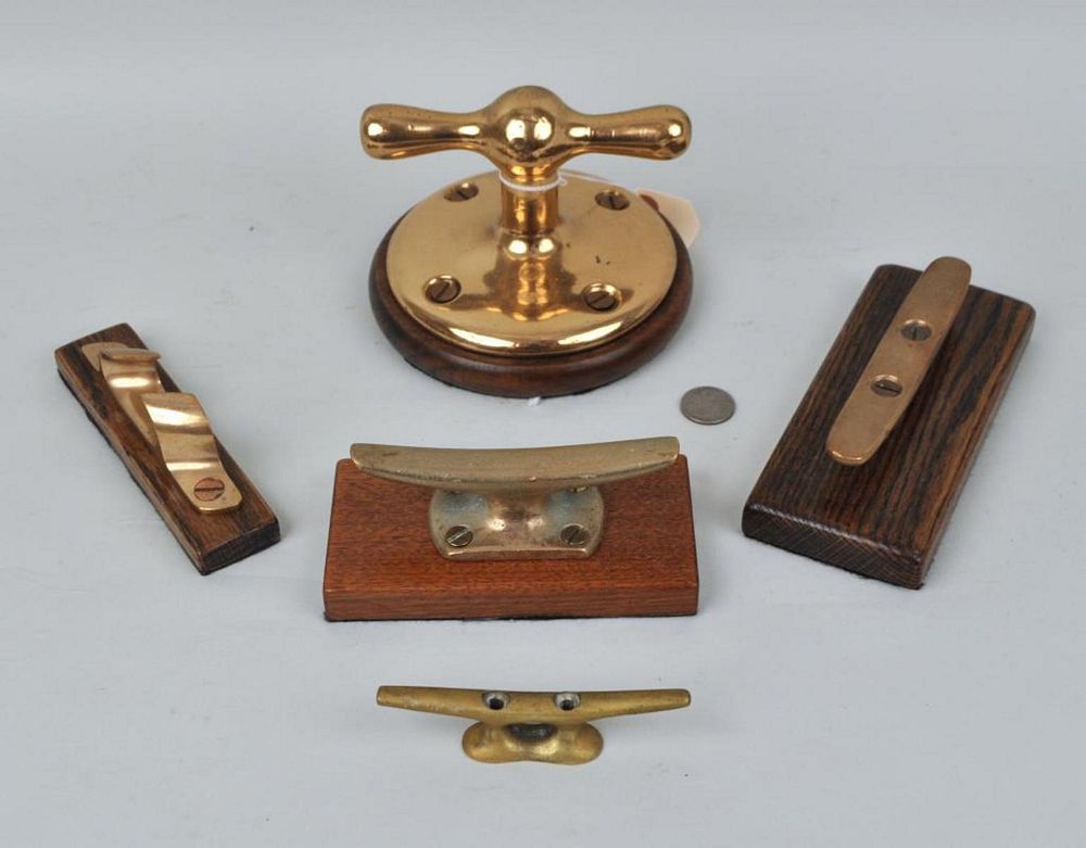 Appraisal: Group Five Brass Ship's Dock Cleats four mounted on wooden