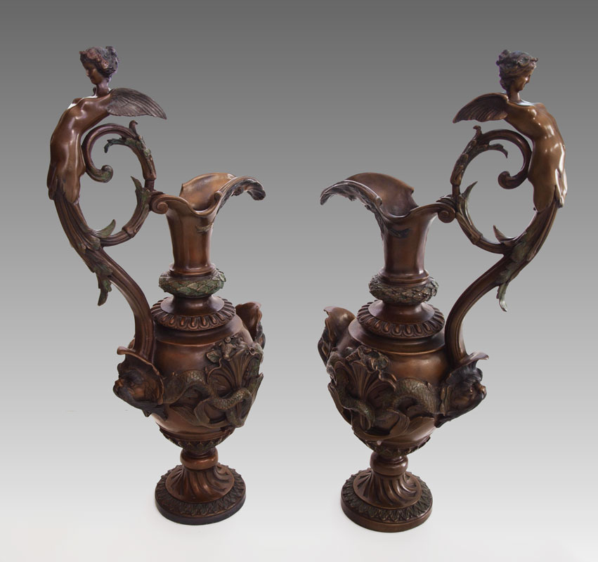 Appraisal: PAIR OF FIGURAL BRONZE EWERS th century production featuring winged