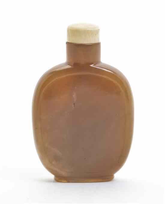 Appraisal: A Carved Hardstone Snuff Bottle of caramel color stone having