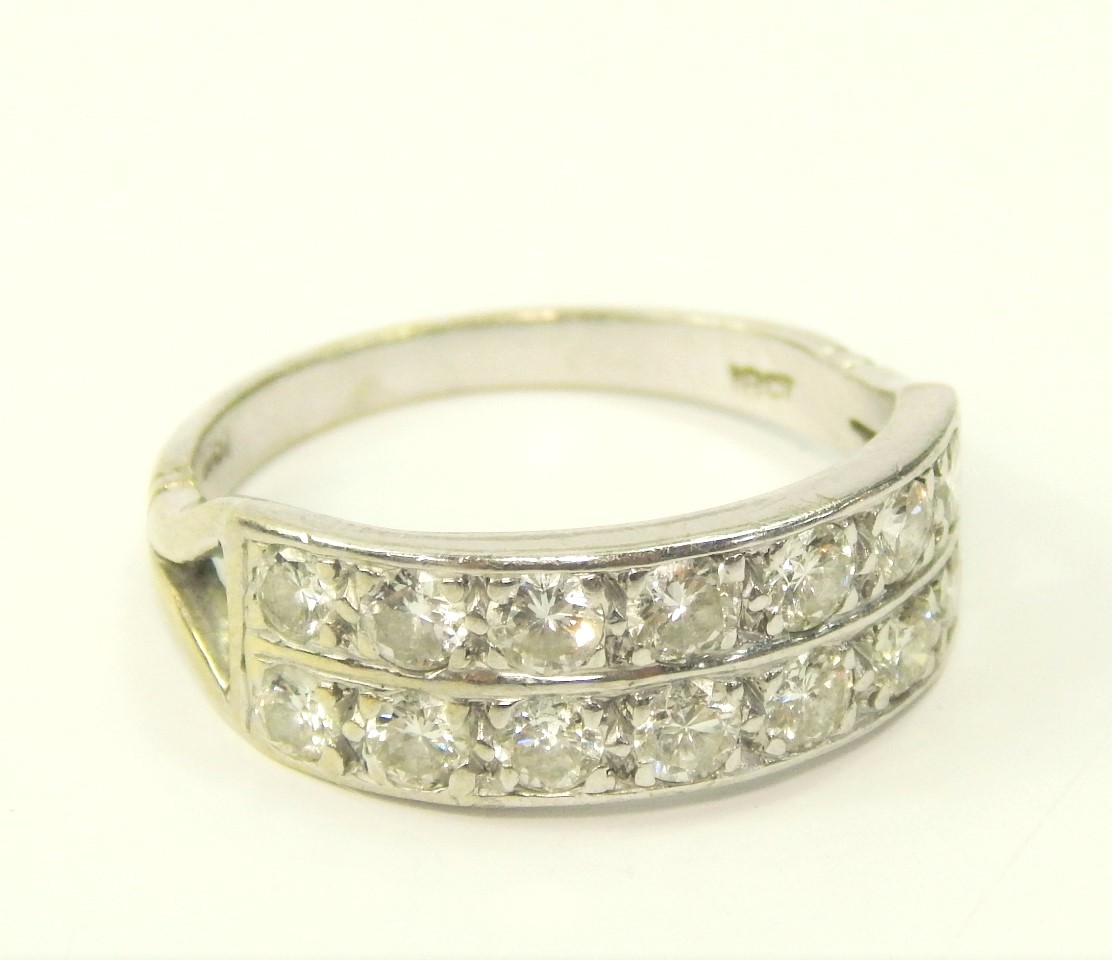 Appraisal: A white metal and diamond half eternity ring set with