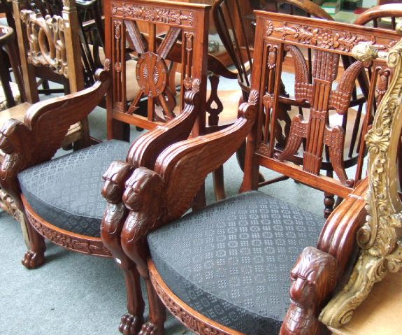 Appraisal: A pair of th century profusely carved padouk wood armchairs