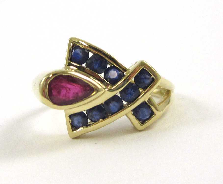 Appraisal: RUBY SAPPHIRE AND TEN KARAT YELLOW GOLD RING set with