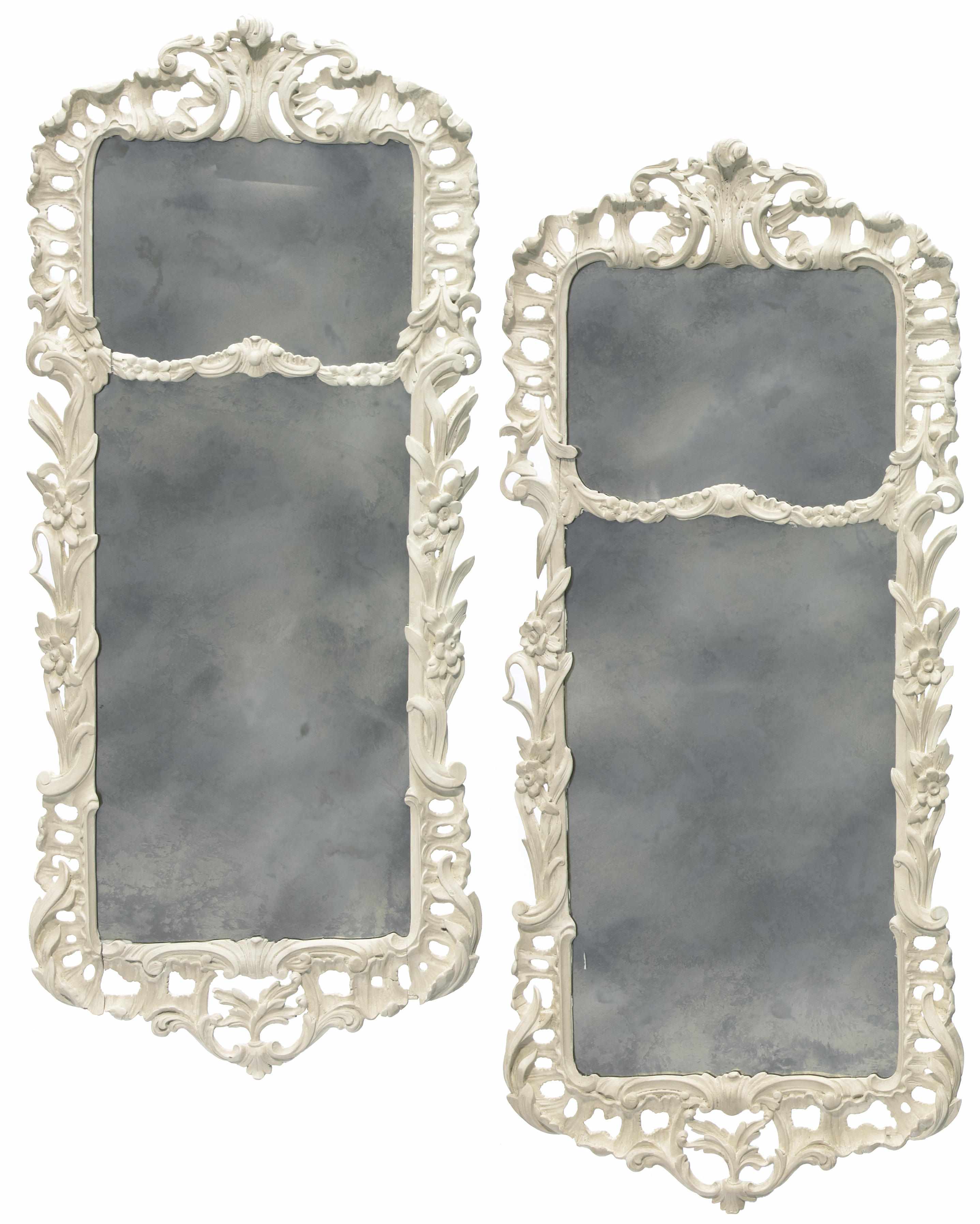 Appraisal: A pair of Rococo style white painted carved wood mirrors