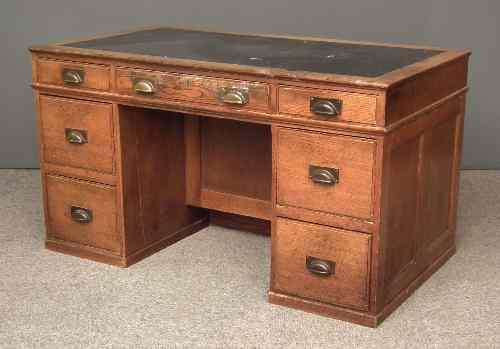 Appraisal: An early th Century panelled oak kneehole desk the top