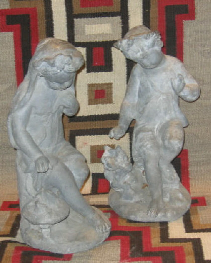 Appraisal: TWO LEAD GARDEN FIGURES Both of seated children one wearing