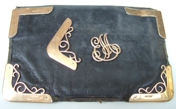 Appraisal: A ct gold mounted rectangular leather wallet decorated with scroll