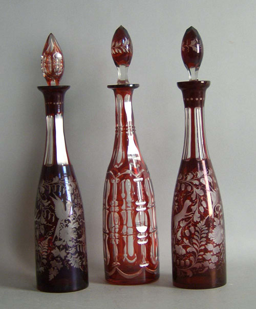 Appraisal: Two cranberry etched glass decanters h together with a rub