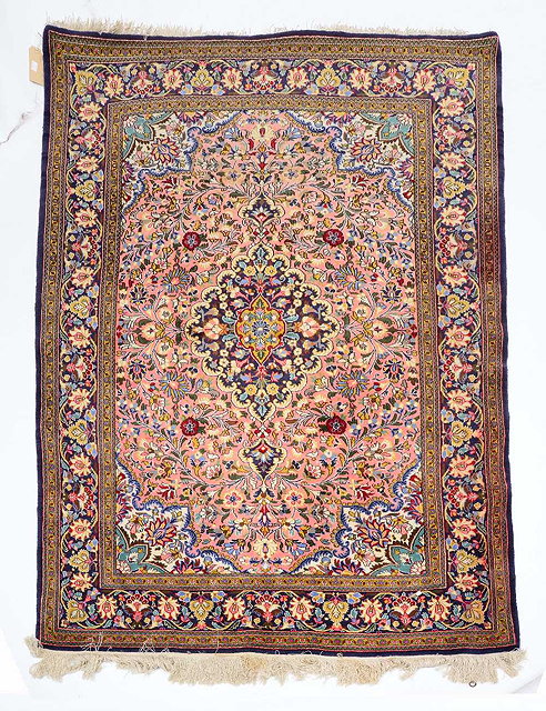 Appraisal: A PERSIAN ROSE PINK GROUND RUG with a central scrolling