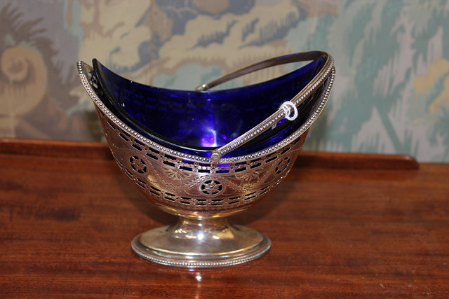 Appraisal: A GEORGE III SILVER HELMET SHAPED PIERCED SUGAR BASKET with