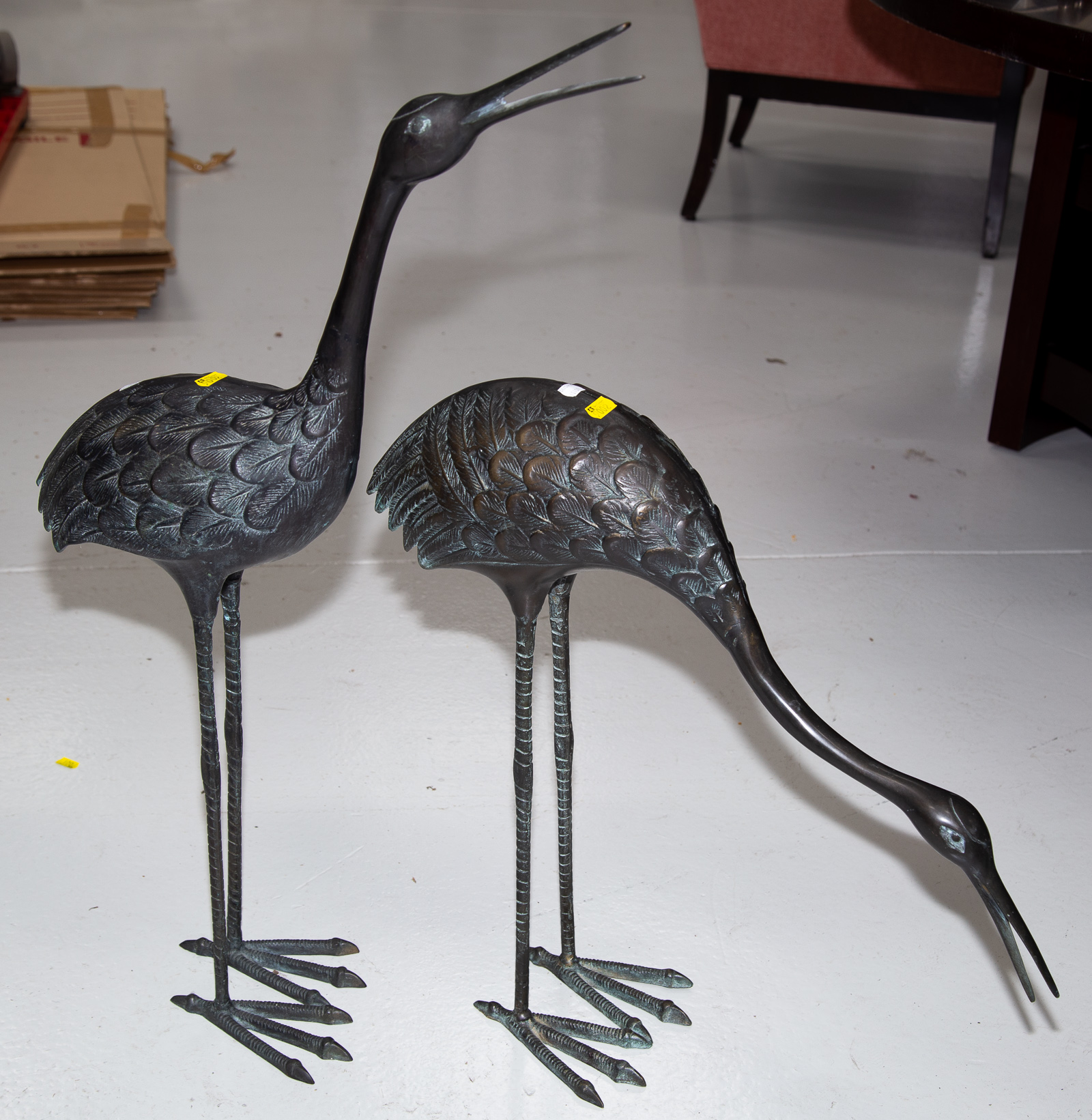 Appraisal: A PAIR OF PATINATED BRONZE HERON FIGURES Modern to in