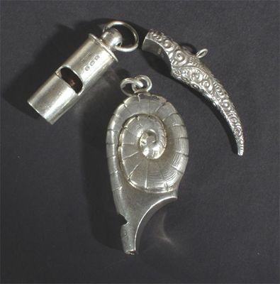 Appraisal: A Thornhill silver novelty shell whistle and two other whistles