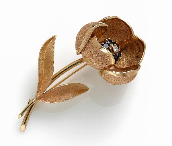 Appraisal: A sapphire and diamond articulated flower brooch mounted in fourteen