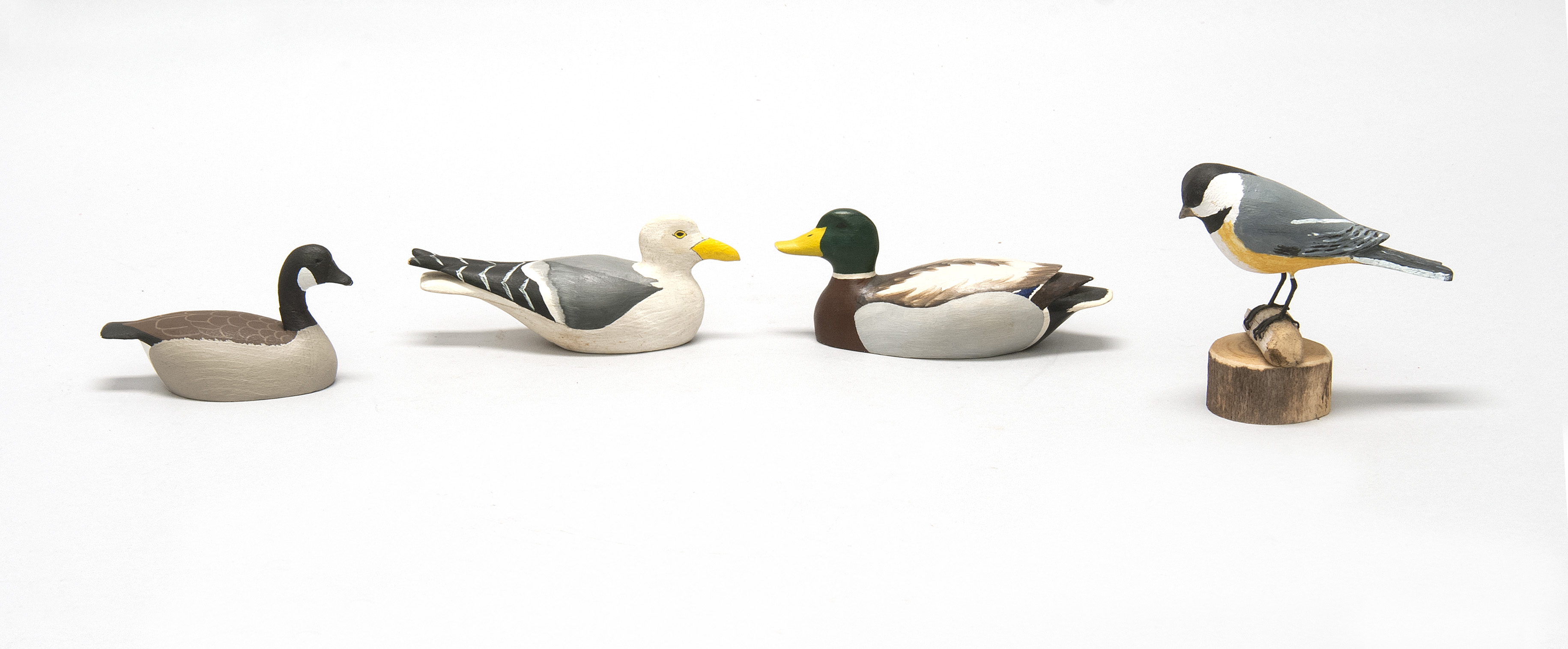 Appraisal: FOUR MINIATURE BIRD CARVINGS a mallard and a seagull both