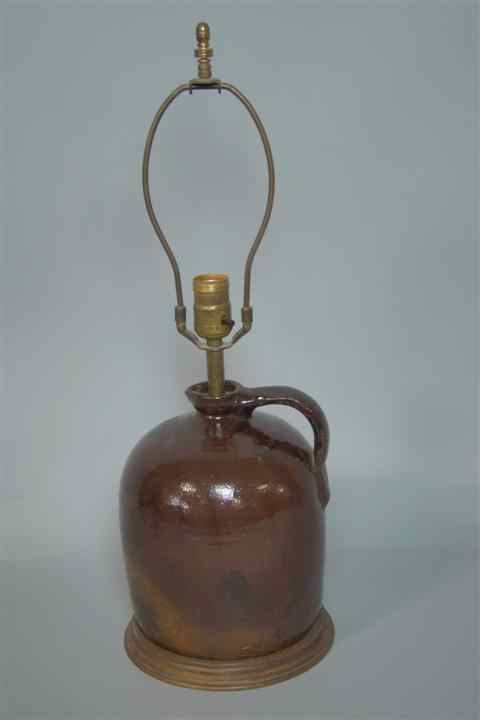 Appraisal: AMERICAN BROWN-GLAZED STONEWARE JUG with short pinched spot strap handle