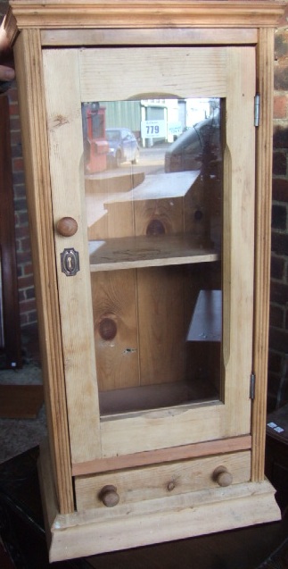 Appraisal: A th century pine hanging cupboard with a single drawer