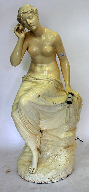 Appraisal: A PLASTER STATUE of a semi clad female seated figure