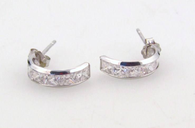 Appraisal: A pair of half hoop ear studs each set with