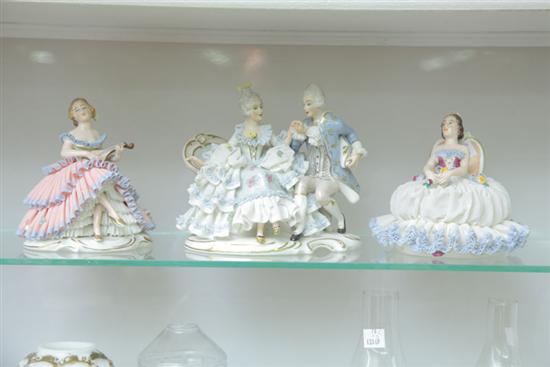 Appraisal: THREE DRESDEN FIGURINES All with elaborate laced attire A courting