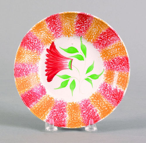 Appraisal: Red and yellow rainbow spatter saucer th c with thistle