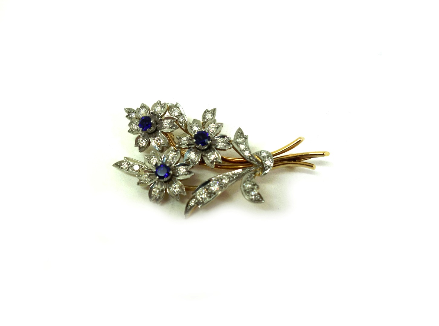 Appraisal: A gold platinum sapphire and diamond flower spray brooch 's