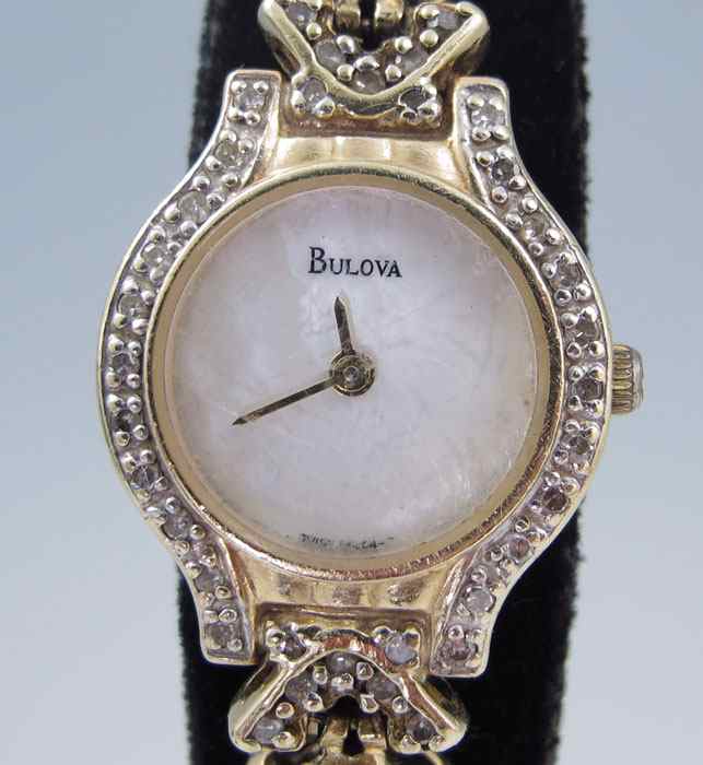 Appraisal: LADIES BULOVA K GOLD AND DIAMOND DRESS WATCH The K