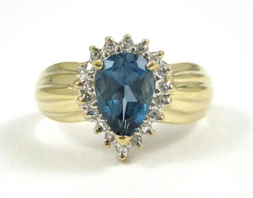 Appraisal: BLUE TOPAZ AND FOURTEEN KARAT GOLD RING with round-cut diamonds