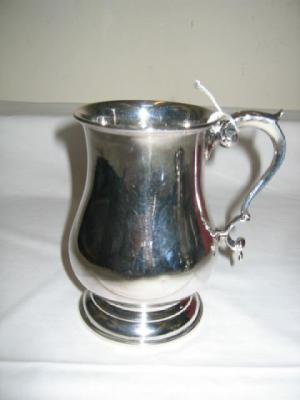 Appraisal: A GEORGIAN STYLE TANKARD of baluster form with moulded rim