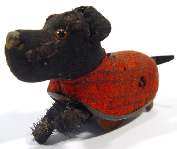 Appraisal: Schuco tinplate clockwork terrier dog with tartan jacket and felt