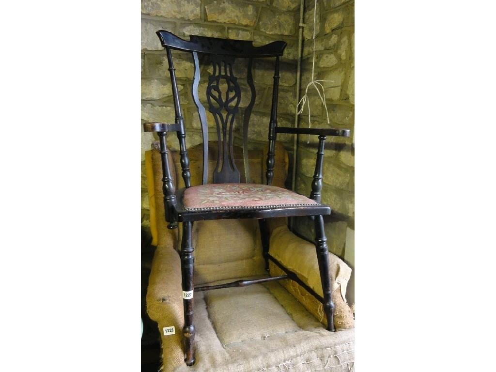 Appraisal: An Edwardian open elbow chair with pierced central splat over