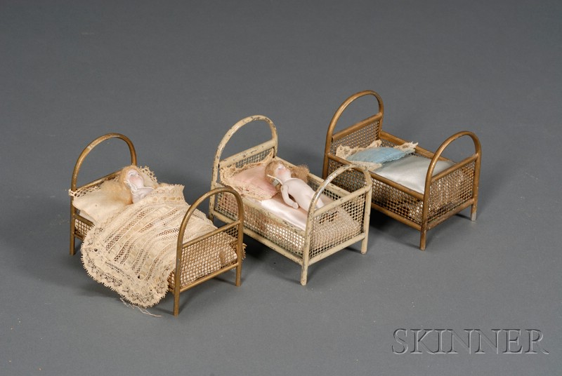 Appraisal: Three Painted Metal Dollhouse Beds and Two All-Bisque Dolls early