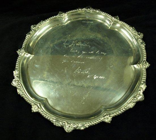 Appraisal: A circular salver with gadroon and shell border with presentation