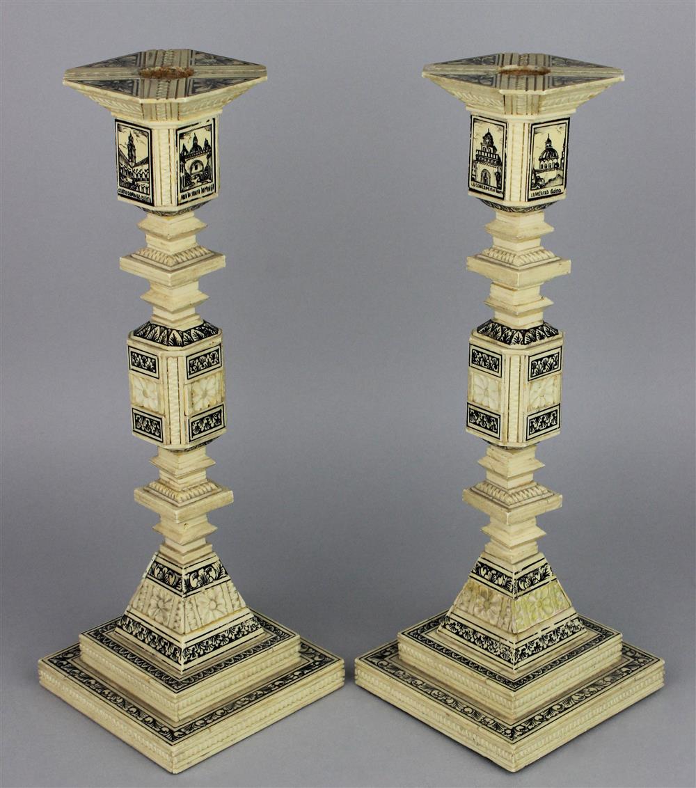 Appraisal: PAIR OF COMPOSITE BONE CANDLESTICKS with ink decorated rectangular plaques