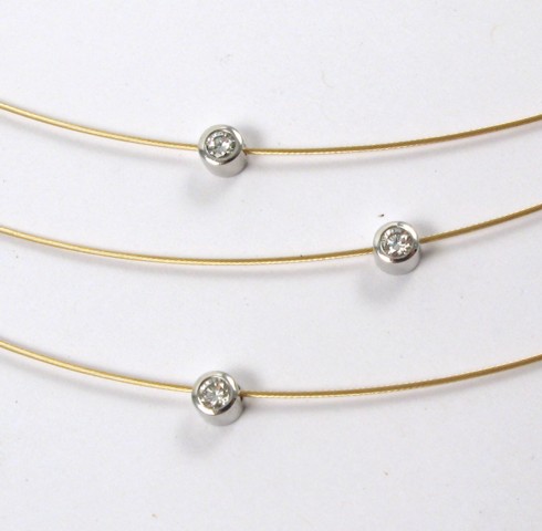 Appraisal: DIAMOND AND EIGHTEEN KARAT GOLD CHOKER The three wire gold