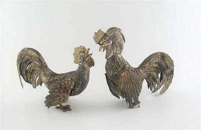 Appraisal: A pair of parcel-gilt Spanish metalware fighting cocks textured plumage