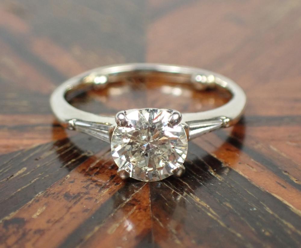 Appraisal: ESTATE THREE-STONE DIAMOND AND FOURTEEN KARAT GOLD RING The k