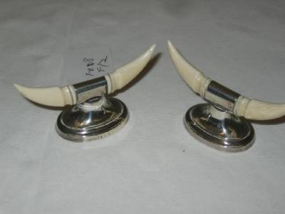 Appraisal: A PAIR OF EDWARDIAN CARVER RESTS the ivory handles raised