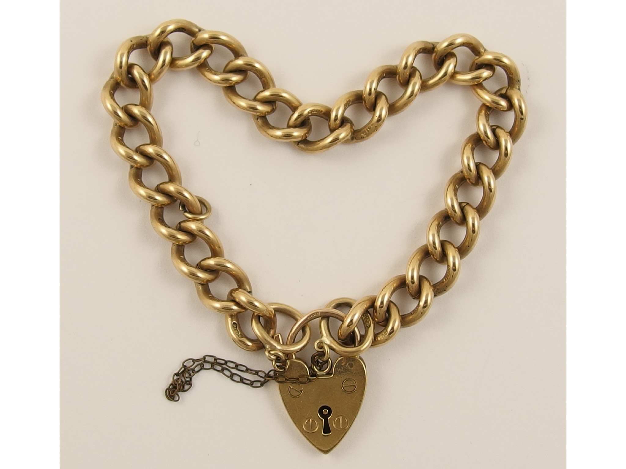 Appraisal: A ct curb link braceletwith heart shaped clasp weight approx