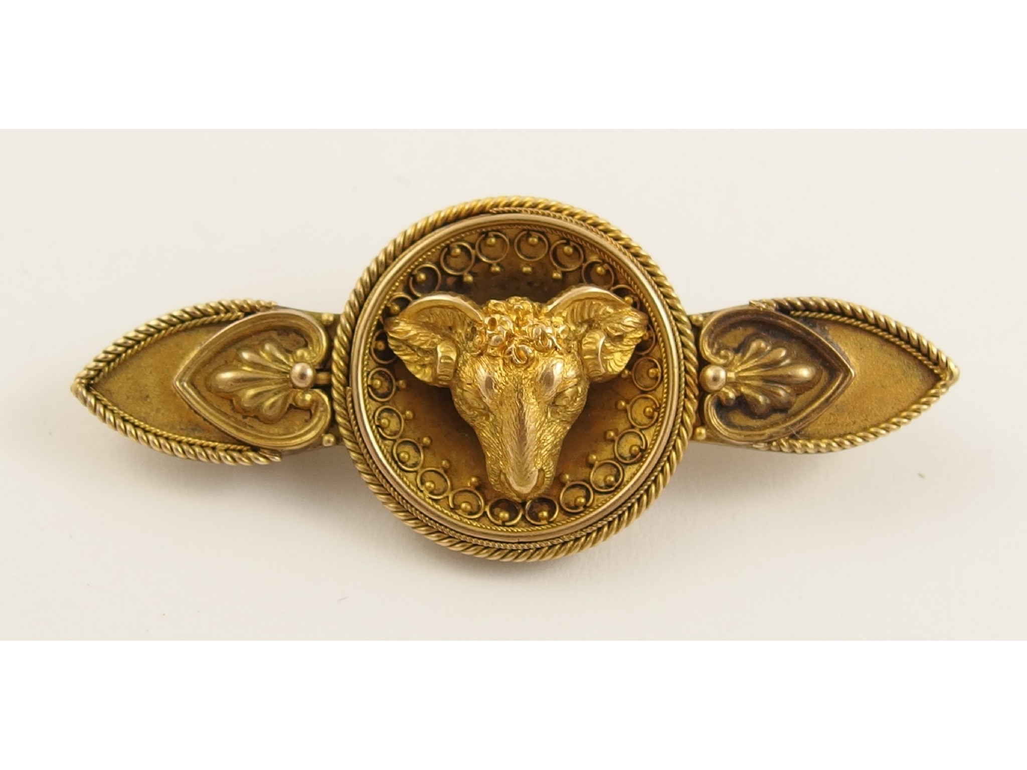 Appraisal: A classical revival brooch of a ram's headwith palmette decoration