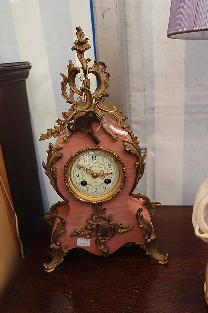 Appraisal: A PINK STONE AND ORMOLU MOUNTED CONTINENTAL MANTLE CLOCK with