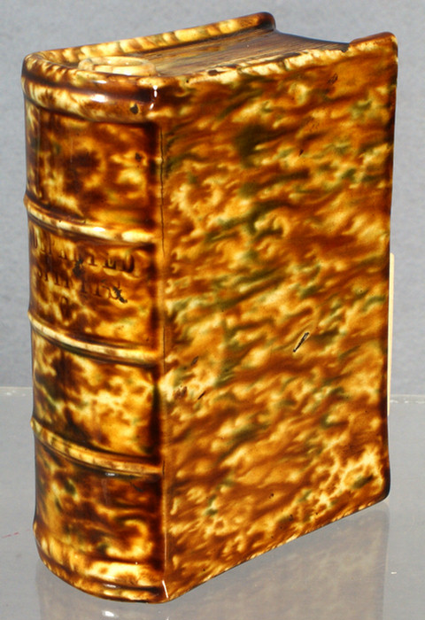 Appraisal: Brown and yellow glazed Bennington book flask Departed Spirits h